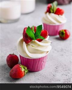 Vanilla cupcake with white cream and strawberries