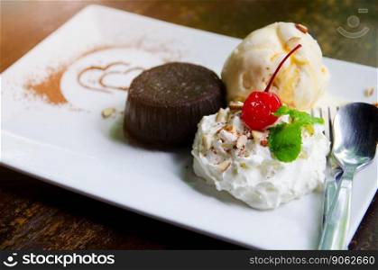 vanilla ice cream and brownie on white plate