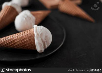 Vanilla Ice Cream in a waffle cones. . Vanilla Ice Cream.