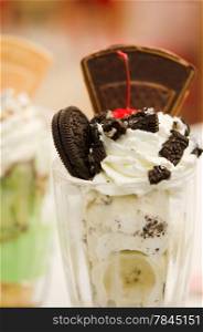 Vanilla ice cream in bowl with chocolate , banana and cherry ,