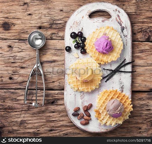 Vanilla ice cream on waffles. Colorful ice cream balls with vanilla pods on waffles