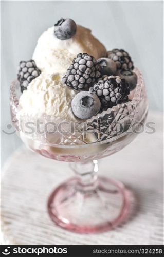 Vanilla ice cream with fozen berries in the glass vase