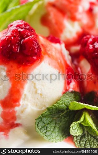 Vanilla ice cream with strawberry jam and mint leaves