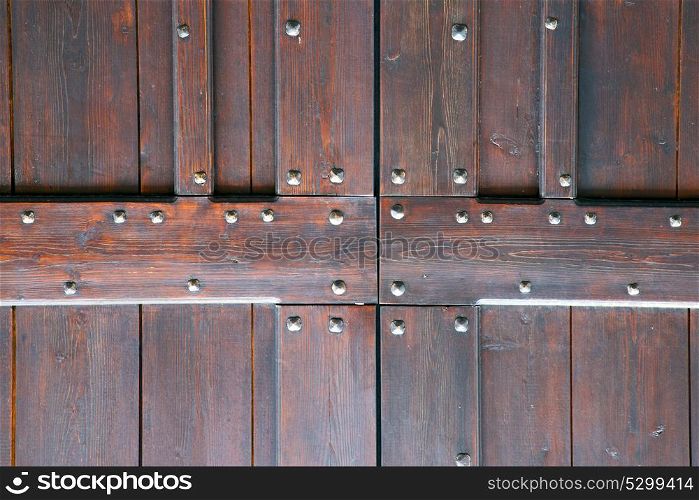 vanzaghello abstract rusty brass brown knocker in a door curch closed wood lombardy italy varese