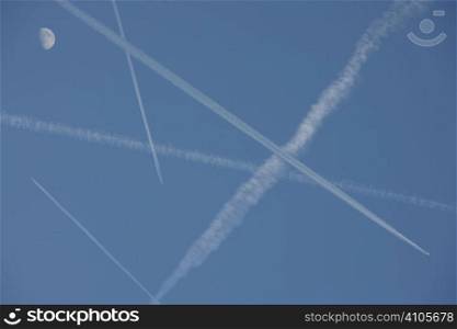vapour trails from aeroplanes going in different directions