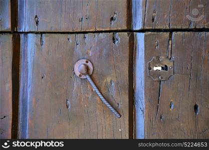 varese abstract rusty brass brown knocker in a door closed wood mornago lombardy italy