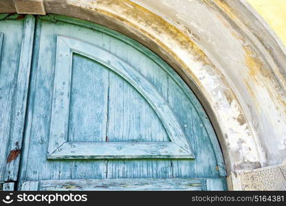 varese abstract rusty brass brown knocker in a door curch closed wood lombardy italy sumirago