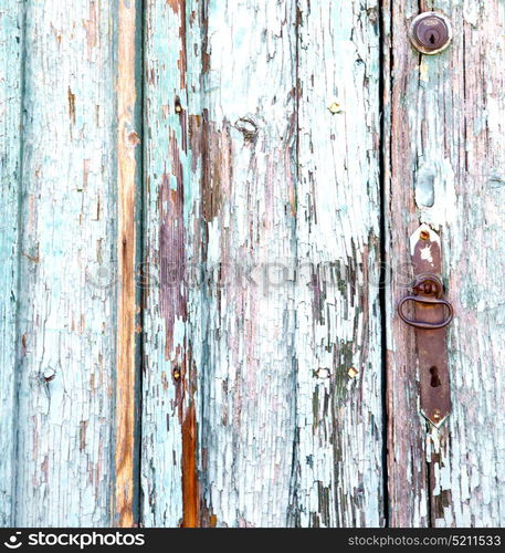 varese abstract rusty brass brown knocker in a door curch closed wood lombardy italy sumirago