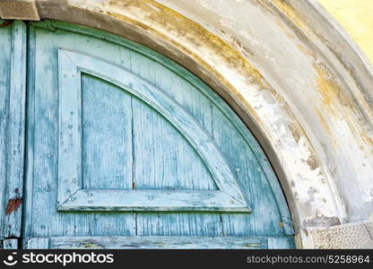 varese abstract rusty brass brown knocker in a door curch closed wood lombardy italy sumirago