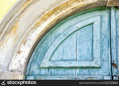 varese abstract rusty brass brown knocker in a door curch closed wood lombardy italy sumirago