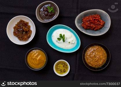 Variation of sauces and dips on wood background.. Variation of sauces and dips on wood background