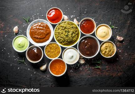Variations of delicious sauces. On dark rustic background. Variations of delicious sauces.