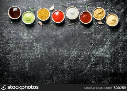 Variations of different types of sauces. On dark rustic background. Variations of different types of sauces.