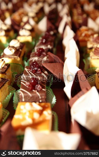 Varieties of cakes individual decorative desserts on the table at a luxury event, gourmet catering sweets