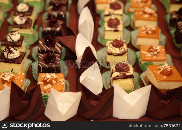 Varieties of cakes individual decorative desserts on the table at a luxury event, gourmet catering sweets