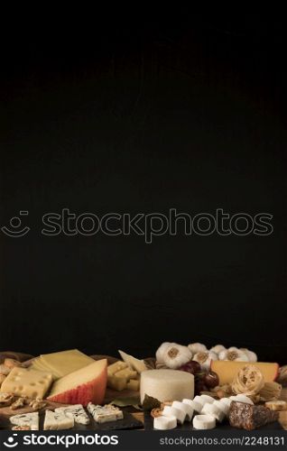 variety cheeses against black background