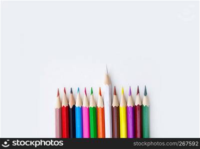 Variety color of crayon pencils with selective focus on the white color isolated on white background with copy space. View from above, Closeup. Wide banner.