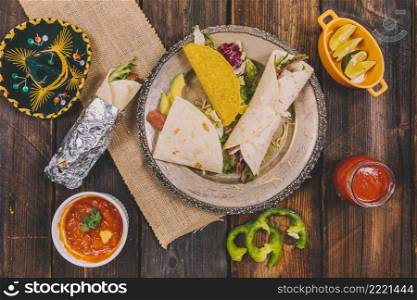 variety mexican food with hat wooden table