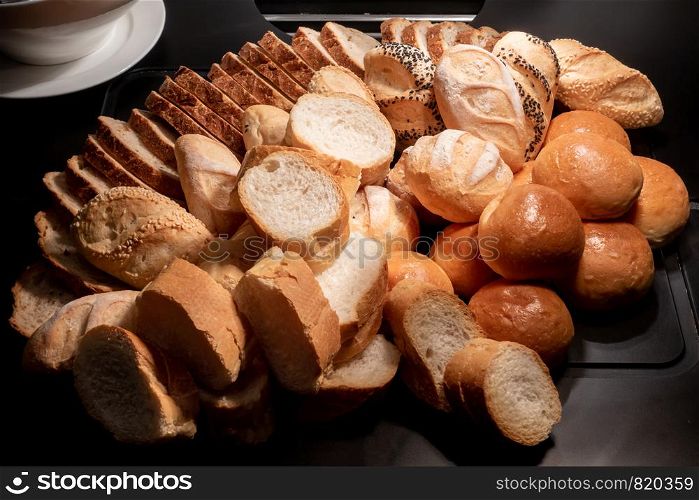 variety of bakery bread and rolls station in buffet line