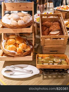 variety of bakery bread and rolls station in buffet line
