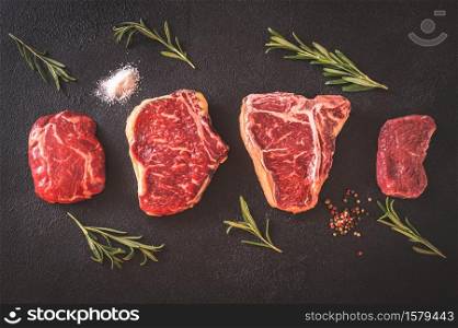 Variety of beef steaks on dark background