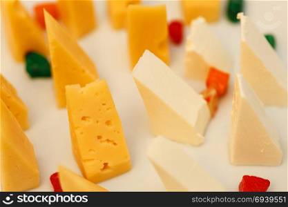 Variety of cheese. Cut french cheese blocks background close up