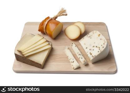 Variety of cheese on wooden platter white background
