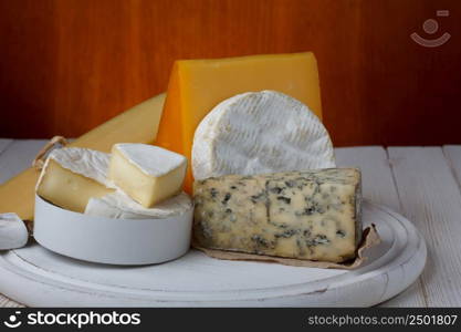 Variety of cheese on wooden table