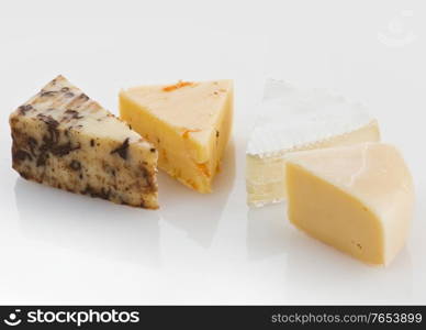 Variety of Cheese Slices On White Background