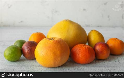 Variety of citrus fruit on the wooden background