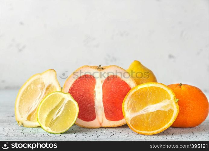 Variety of citrus fruit on the wooden background
