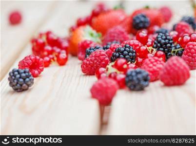 Variety of different berries on a wooden table