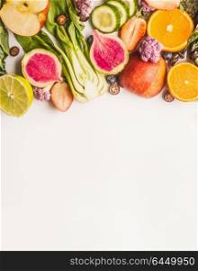 Variety of fresh colorful fruits, citrus and vegetables on white background, top view, border. Healthy food and clean eating ingredients concept