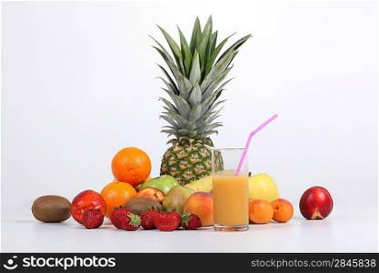 Variety of fruit behind glass of juice