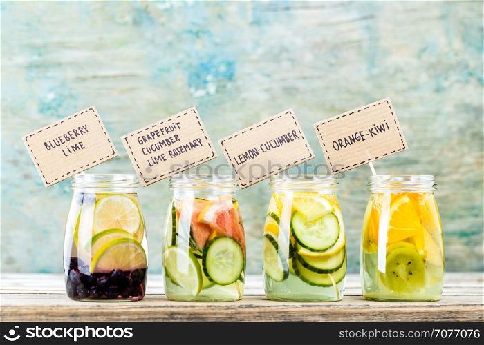 Variety of fruit infused detox water in jars for a healthy diet eating