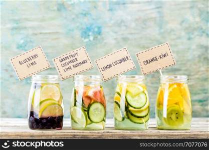 Variety of fruit infused detox water in jars for a healthy diet eating