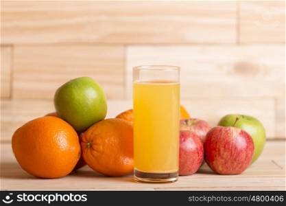variety of fruits and orange juice on a woden table, studio picture