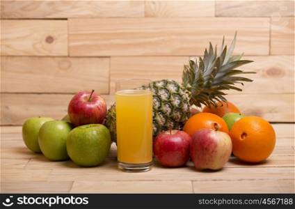 variety of fruits and orange juice on a wooden table, studio picture