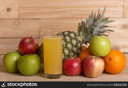 variety of fruits and orange juice on a wooden table, studio picture