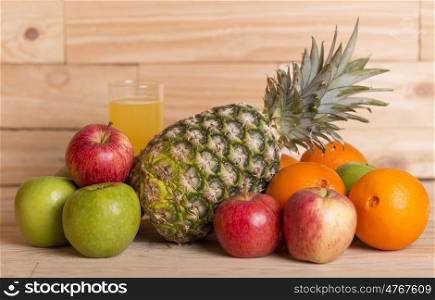 variety of fruits and orange juice on a wooden table, studio picture