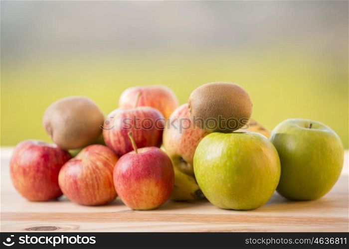 variety of fruits on a wooden table, outdoor