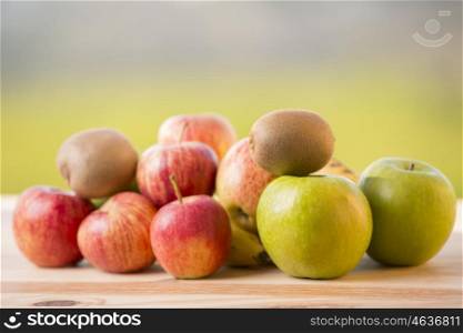 variety of fruits on a wooden table, outdoor
