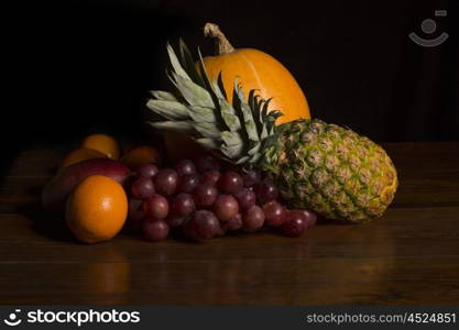 variety of fruits on a wooden table, studio picture