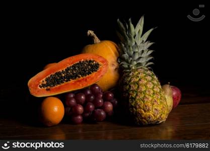 variety of fruits on a wooden table, studio picture