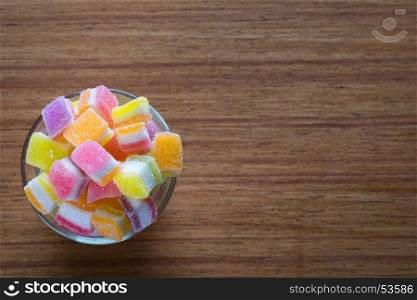variety of gelly and candies on a wooden background.