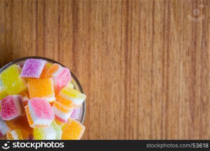 variety of gelly and candies on a wooden background.