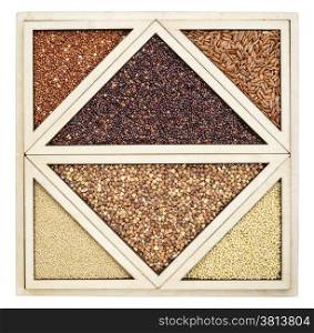 variety of gluten free grains (red and black quinoa, buckwheat, brown rive, amaranth and millet) in a wooden tray