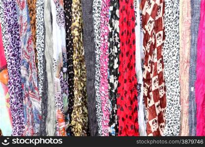 Variety of Hanging Scarves Providing Colourful Backdrop for Graphic Artists