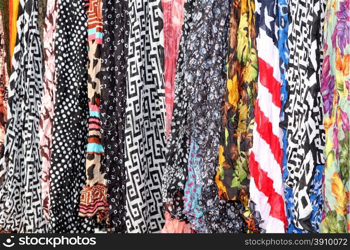 Variety of Hanging Scarves Providing Colourful Backdrop for Graphic Artists