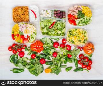 Variety of Healthy salads in lunch boxes with ingredients white wooden background , top view